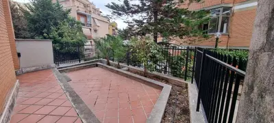 a brick walkway in front of a building with a fence at Er Core Nostro in Rome