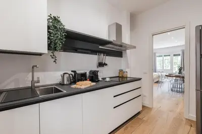 a kitchen with white cabinets and a sink at The Best Rent - Spacious three-bedroom apartment in Prati area in Rome