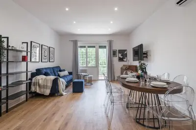 a living room with a table and a couch at The Best Rent - Spacious three-bedroom apartment in Prati area in Rome