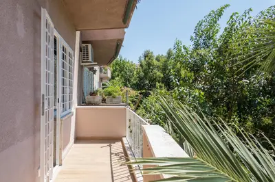 a balcony of a house with trees and plants at The Best Rent - Spacious three-bedroom apartment in Prati area in Rome