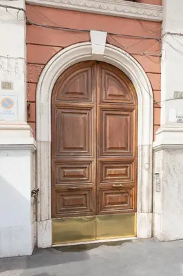 a large wooden door on the side of a building at B&B Del Mercato in Rome