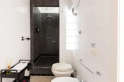 a white bathroom with a shower and a toilet at B&B Del Mercato in Rome