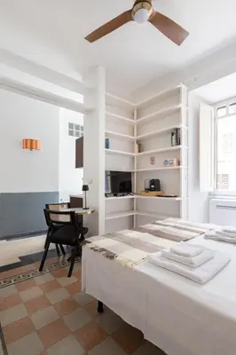 a white bedroom with a bed and a desk at B&B Del Mercato in Rome