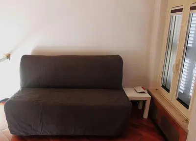a brown bed in a room with a window at Anita's House in Rome
