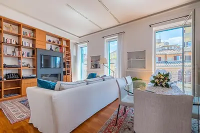 a living room with a couch and a table at HT Borromini Penthouse in Rome