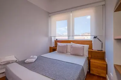 a bedroom with a bed with two pillows and a window at HT Borromini Penthouse in Rome
