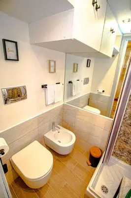 a white bathroom with a toilet and a sink at Eleganza e Confort nel Cuore dei Parioli in Rome