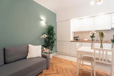a living room and kitchen with a couch and a table at Emma Bliss Apartment in Rome