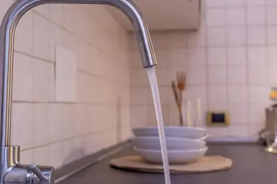 a kitchen sink with water coming out of a faucet at iFlat Space and Comfort in the Heart of Monti in Rome