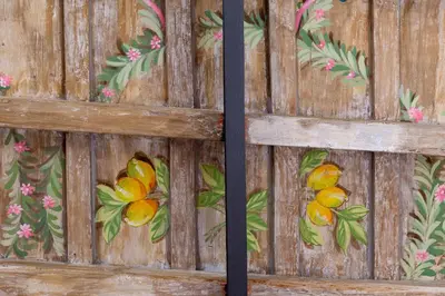 a wooden fence with flowers and oranges painted on it at iFlat Space and Comfort in the Heart of Monti in Rome