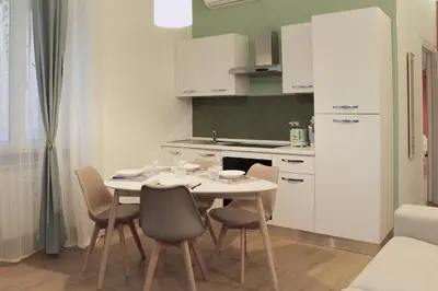 a kitchen with a table and chairs in a room at Trastevere Elite 