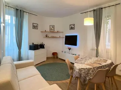 a living room with a table and a tv at Trastevere Elite 