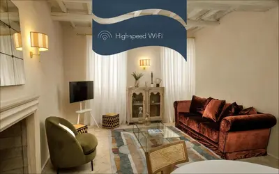 a living room with a couch and a tv at Daplace - Camelia Apartment in Rome