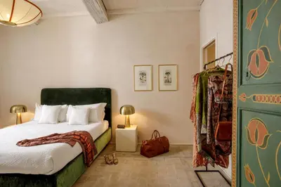 a bedroom with a bed with a green headboard at Daplace - Camelia Apartment in Rome