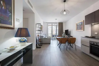 a kitchen and living room with a table and chairs at Sky Luxury in Rome