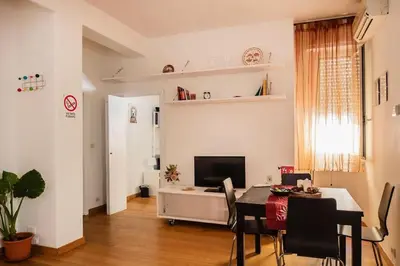 a living room with a dining table and a television at Casa Broccoletti in Rome