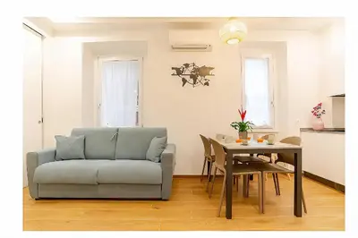 a living room with a couch and a table at Lux Vaticana Suite in Rome