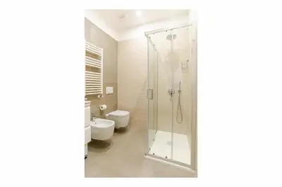 a bathroom with a shower and a toilet at Lux Vaticana Suite in Rome