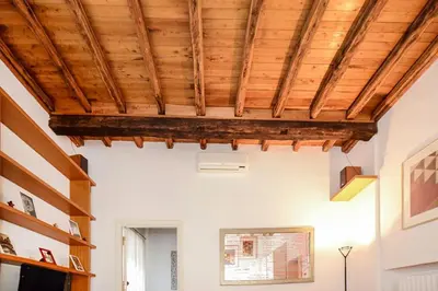 a room with a wooden ceiling with beams at PANTHEON 2 - LARGE APARTMENT IN THE HEARTH OF ROME a in Rome