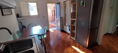 a living room with a table and a refrigerator at Casa Argia in Rome