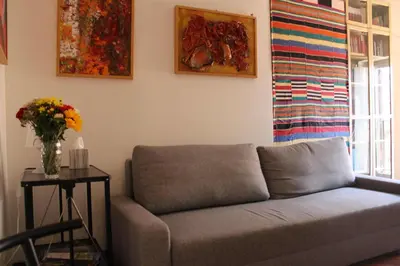a living room with a couch and a table with flowers at Casa Argia in Rome