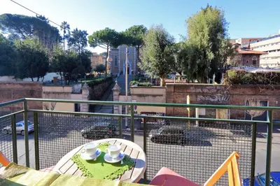 a balcony with a table and a view of a street at Apartment Marrucini in Rome
