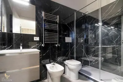 a bathroom with a toilet and a sink and a shower at San Paolo Superior Room in Rome