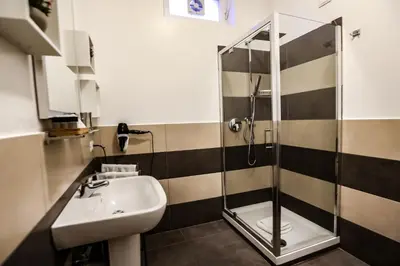 a bathroom with a sink and a shower at Relais Circo Massimo in Rome