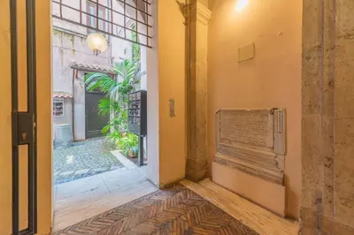 an entrance to a building with a sign on the wall at Maison Leo a Largo Argentina in Rome