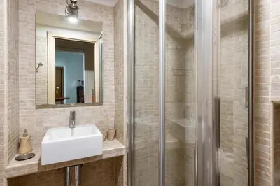 a bathroom with a sink and a shower at Maison Leo a Largo Argentina in Rome