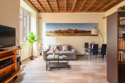 a living room with a couch and a table at Maison Leo a Largo Argentina in Rome