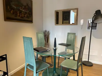 a table and chairs with a laptop on top of it at CBMC - Couldn't Be More Central in Rome