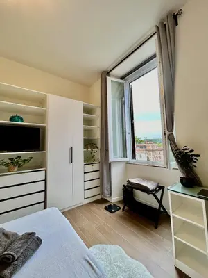 a bedroom with a bed and a large window at CBMC - Couldn't Be More Central in Rome