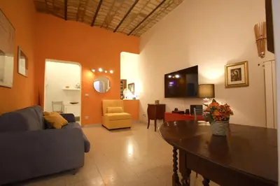 a living room with a couch and a table at Manara Holiday House in Rome