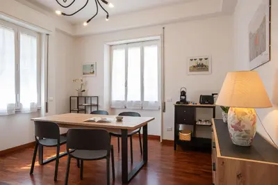 a dining room with a table and chairs at Carpegna Park Apartment by Cornelia subway in Rome