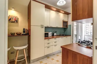 a kitchen with white cabinets and a counter top at Vatican Cartographer in Rome