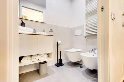 a white bathroom with a sink and a toilet at V Collection Rome Jubilee Guest House in Rome