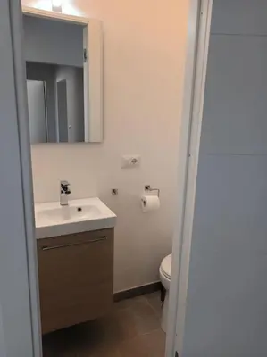 a bathroom with a sink and a toilet and a mirror at Casa Erminia in Rome