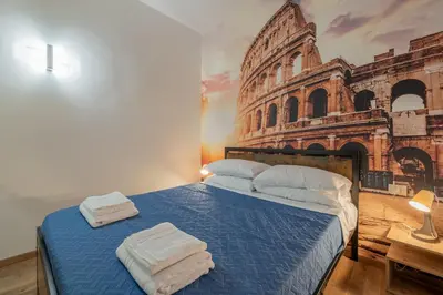 a bedroom with a bed with towels on it at LE TRE M - Guesthouse in Rome