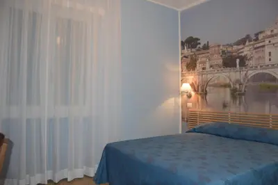 a bedroom with a bed and a large window at Ad Maiora bb Roma Musei Vaticani in Rome