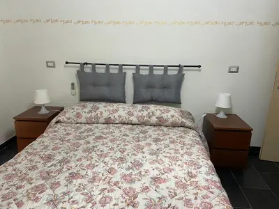 a bedroom with a large bed with two night stands at La casetta di Matteo in Rome