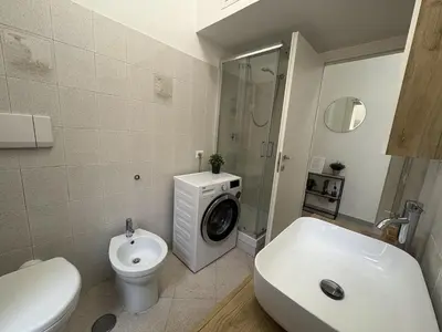 a washing machine in a bathroom with a shower at RHome Apartment in Rome