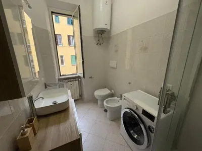 a bathroom with a sink and a mirror at RHome Apartment in Rome