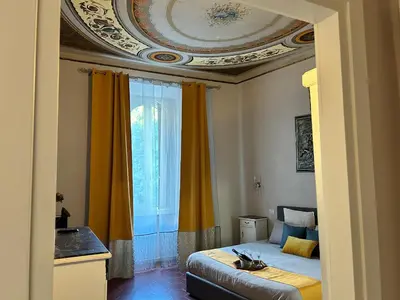 a bedroom with a bed and a large window at dolce casa colosseo 2 in Rome