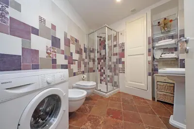 a bathroom with a washing machine and a toilet at dolce casa colosseo 2 in Rome