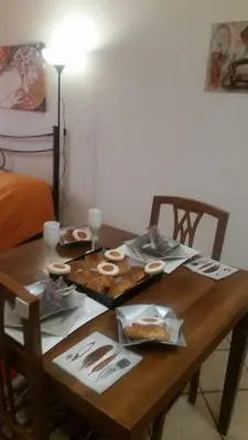a wooden table with food on top of it at San Giovanni In Laterano Daniela Apartment in Rome