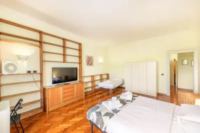 a large room with a bed and a television at Viale Mazzini Big Apartment in Rome