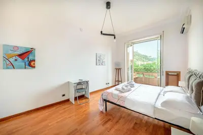 a bedroom with a bed and a large window at Viale Mazzini Big Apartment in Rome
