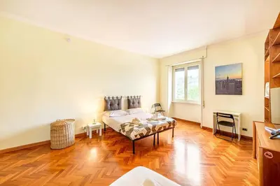 a bedroom with a bed and a large window at Viale Mazzini Big Apartment in Rome