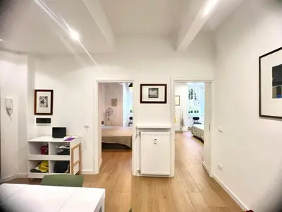 a white living room with a room with a bed at The Stylish at Ponte Milvio in Rome